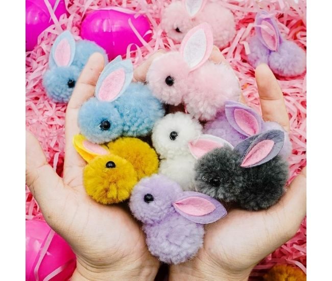 A Pair Hands Holding Plush Baby Easter Bunnies