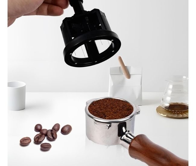 Espresso distribution tool with rotating needles, an adjustable height collar and a magnetic base