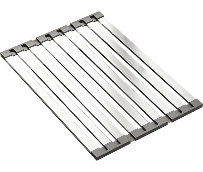 Stainless steel roll-up drying rack laid across a kitchen sink with dishes on it