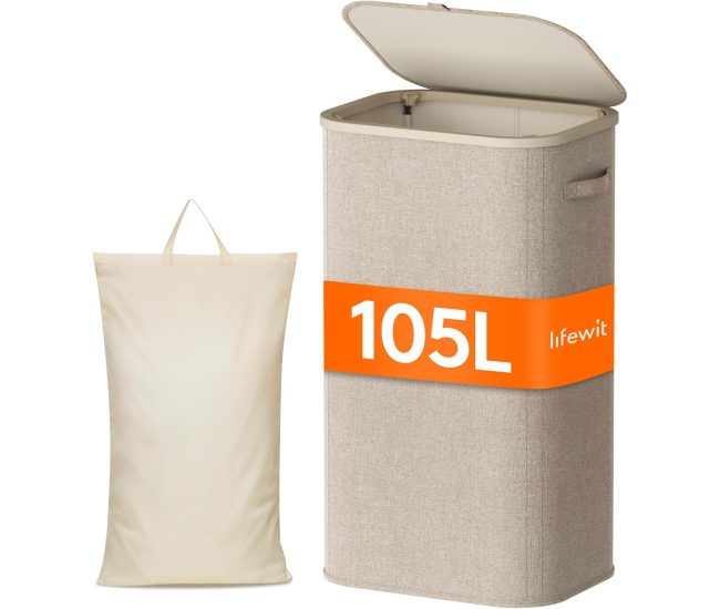 Slim beige laundry hamper with a lid, standing in a narrow gap beside a wardrobe